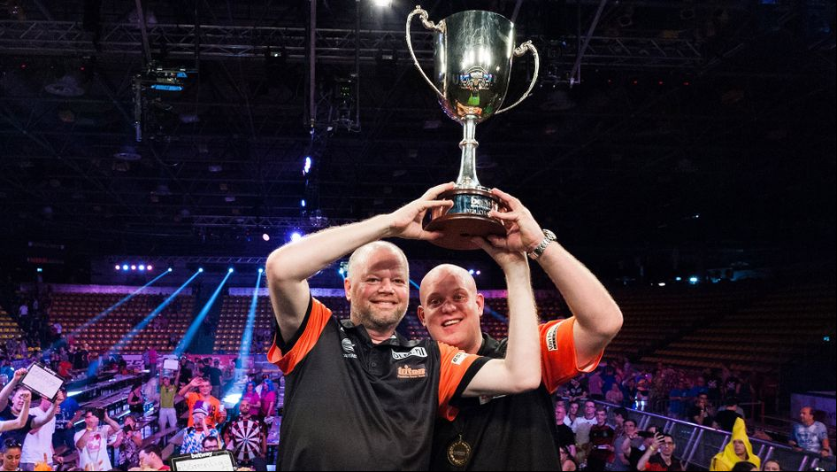 Raymond van Barneveld and Michael van Gerwen lift the World Cup of Darts trophy (Picture: Kelly Deckers/PDC)