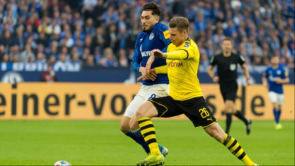 Suat Serdar (left) and Lukasz Piszczek battle for the ball