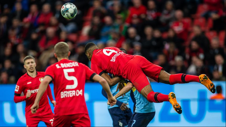 Jonathan Tah beats Patrick Herrmann in the air